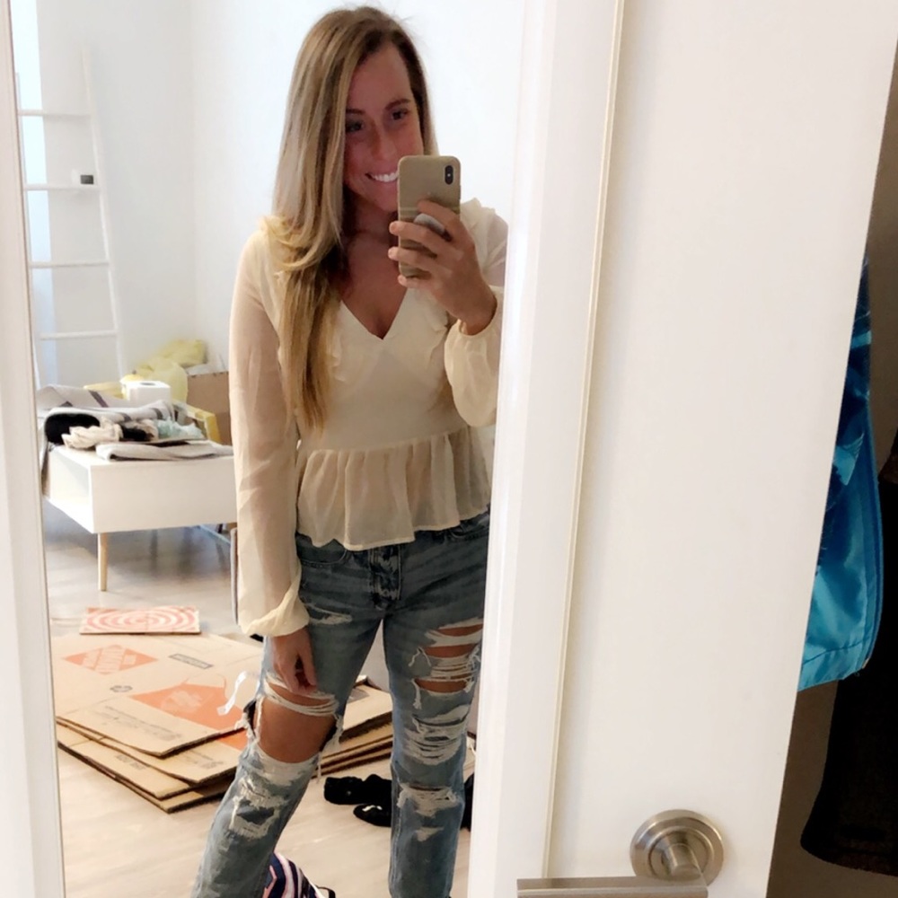 Cream colored ruffled blouse